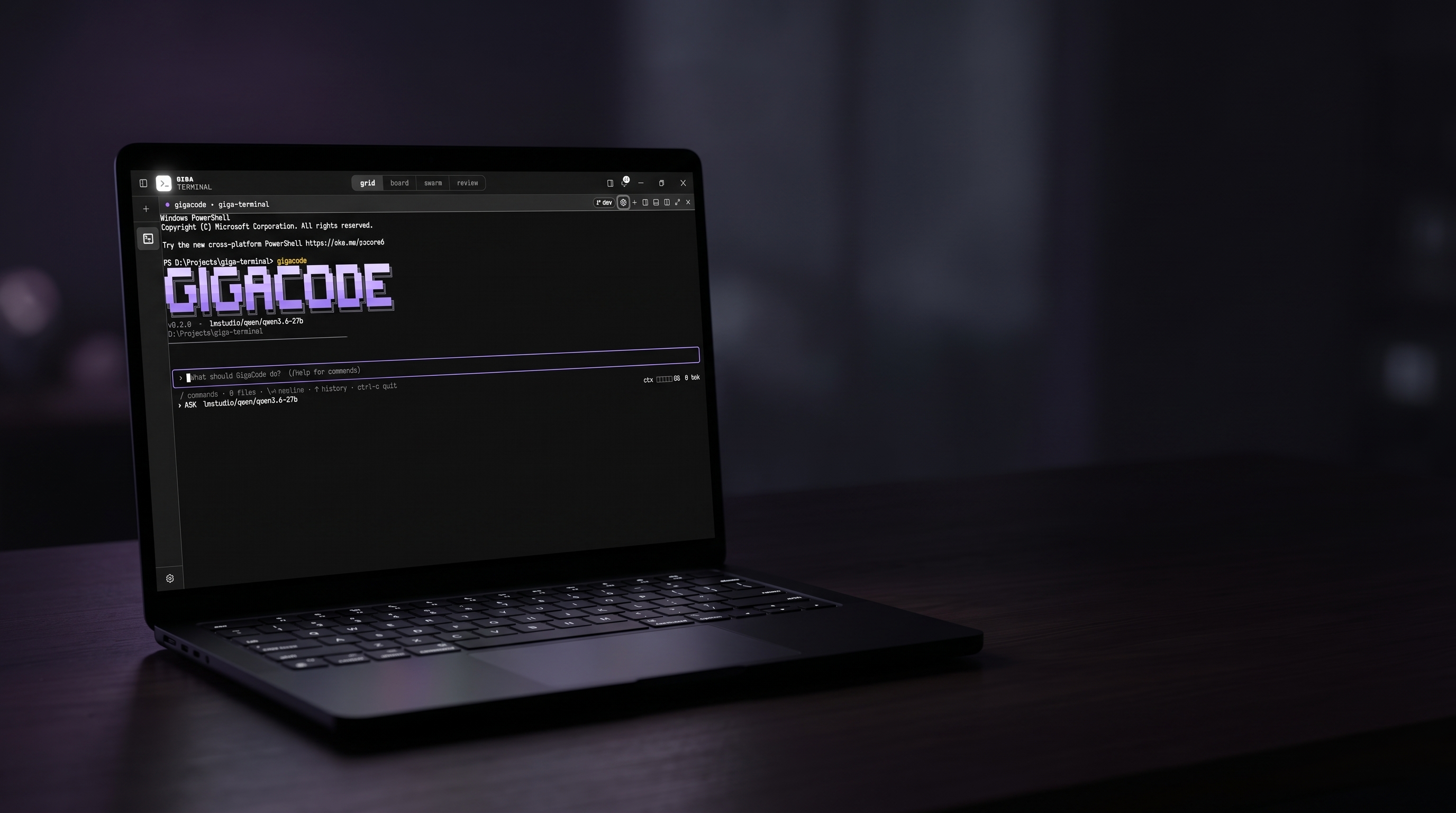 GigaCode’s pixel banner on a laptop beside a mechanical keyboard in a dark room