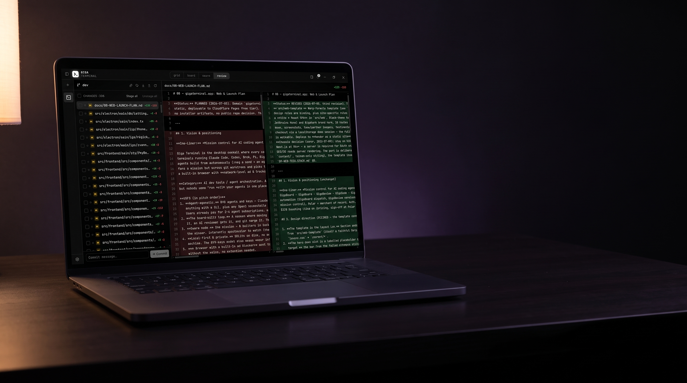 GigaReview’s split diff with red and green columns on a laptop in a dark room